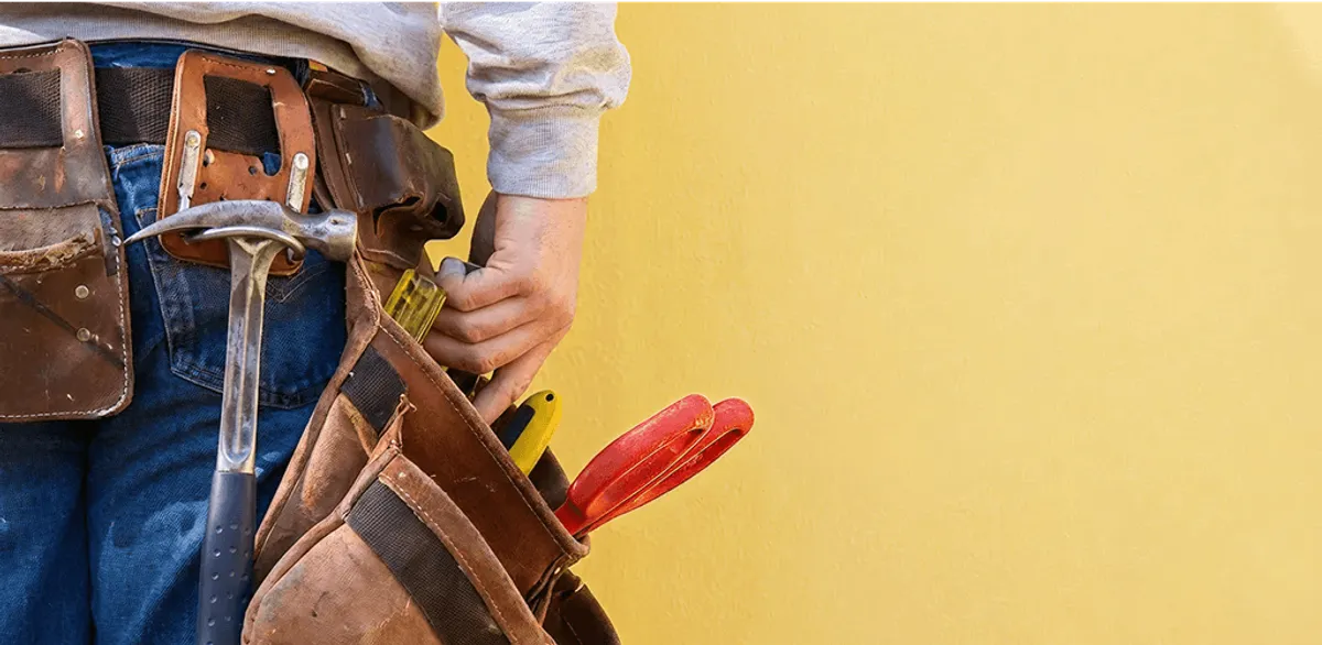 Handyman with tool belt ready for home repairs and maintenance in Santa Ana, CA